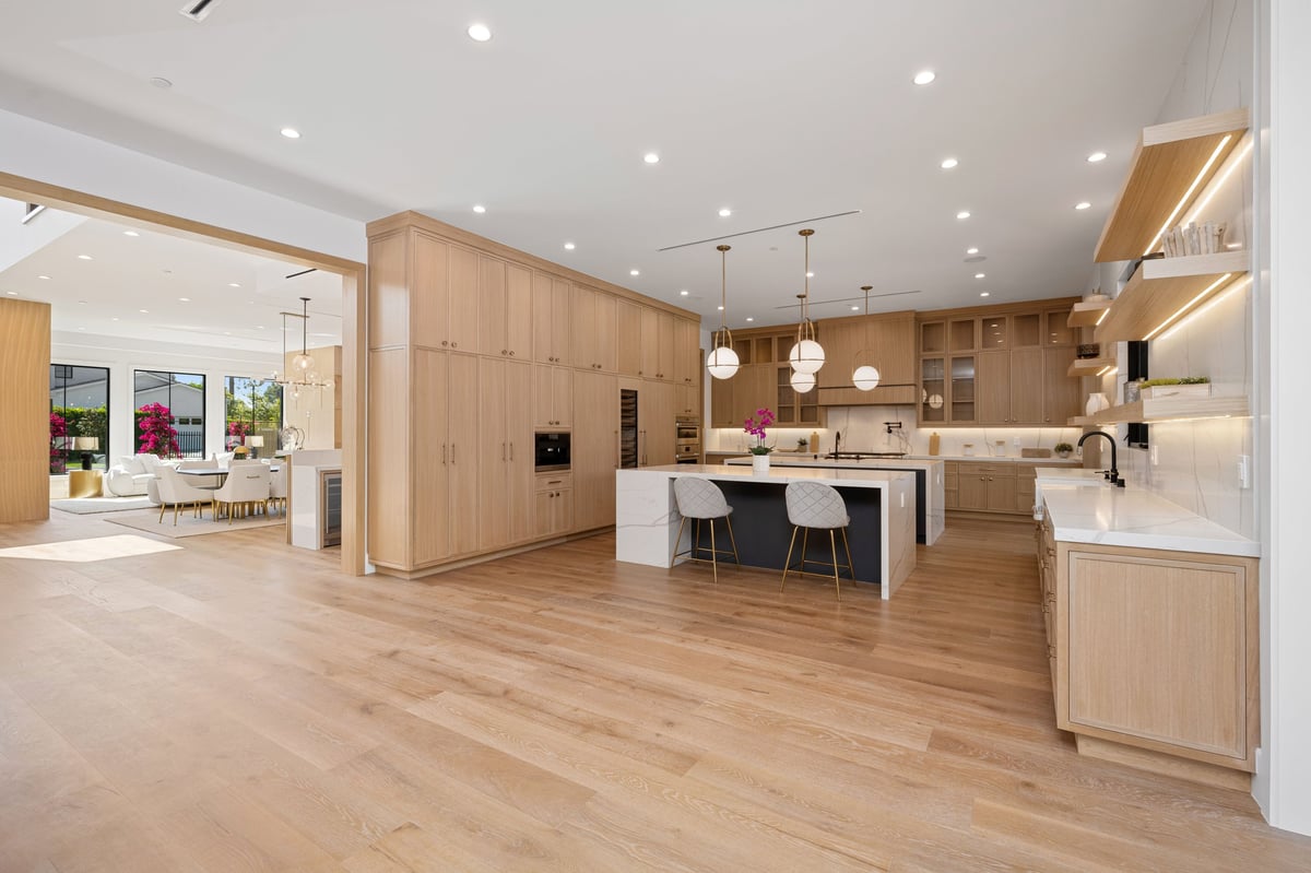 Modern luxury kitchen with light wood cabinetry and flooring