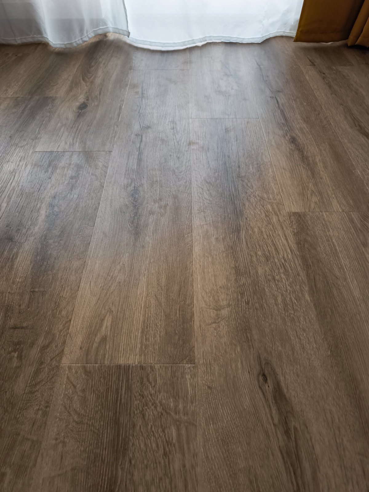 Dark luxury vinyl plank in sunlight